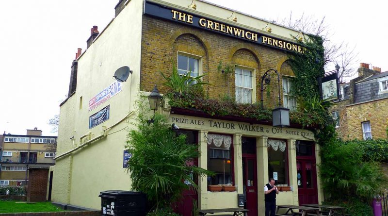The exterior of The Pensioner Pub with green leafy plants around the windows and doors.