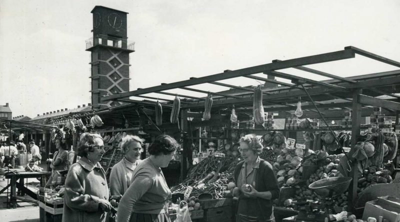 A busy and bustling Chrisp Street Market in 1968 with the Chrisp Street Clock Tower in the background