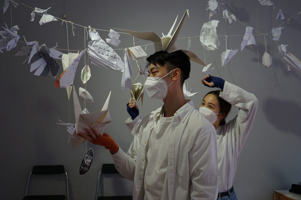 Pui Yung Shum and Ghost perform the folding of the origami