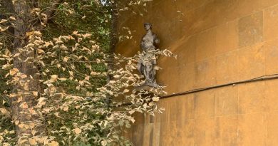 A classical statue of a woman in a toga, attached to the wall of the Lansbury Lawrence School, Poplar, East London