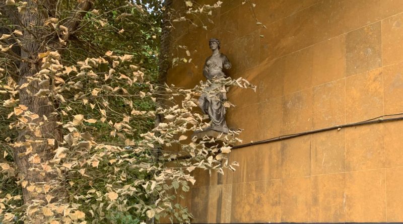 A classical statue of a woman in a toga, attached to the wall of the Lansbury Lawrence School, Poplar, East London