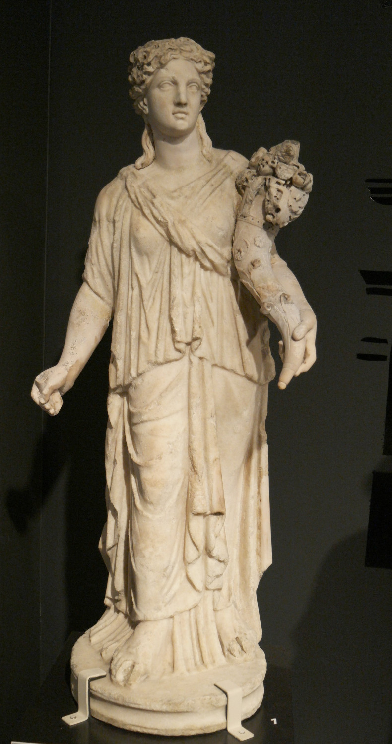 A statue of the Greek god Demeter, holding a cornucopia, a horn filled with fruit and flowers