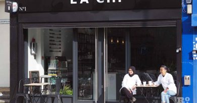 Owners of Cafe La Chi sitting outside their cake and coffee shop in Poplar.