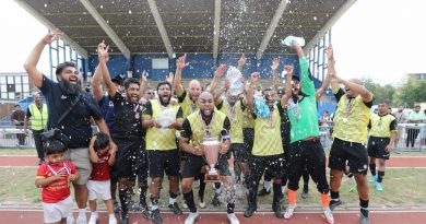 Brick Lane FC celebrate with trophy after winning the Mayor's Cup football tournament.