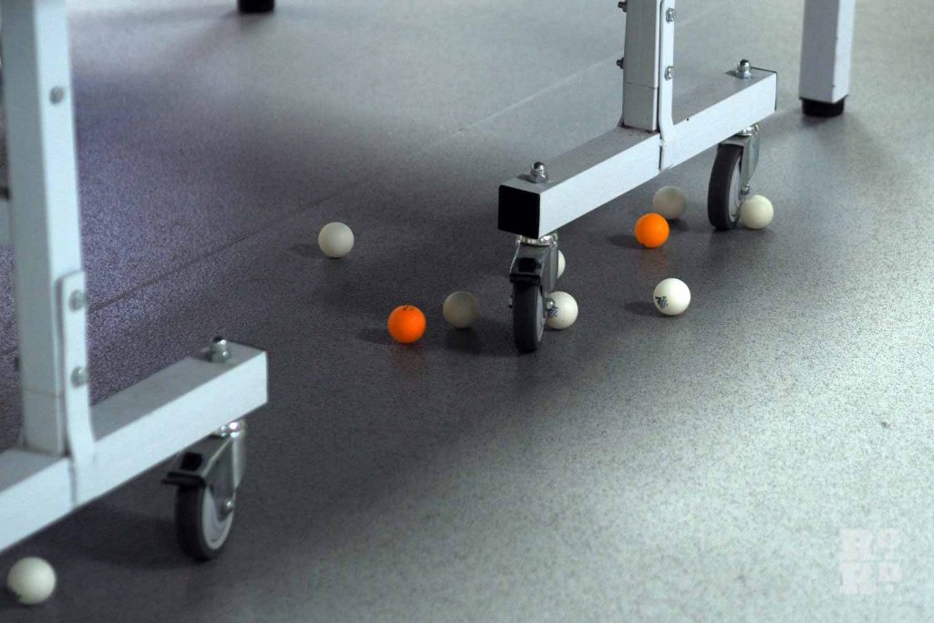 Balls left under a ping pong table during a game at the Chinese Association of Tower Hamlets in Limehouse, Poplar.
