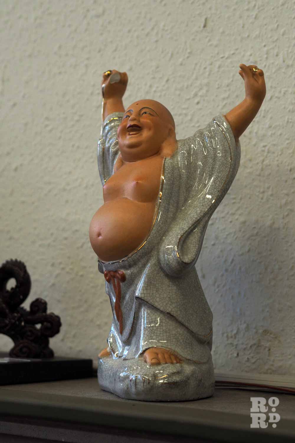 A Smiling Buddha statue in the Chinese Association of Tower Hamlets at Sailors Palace, Limehouse.