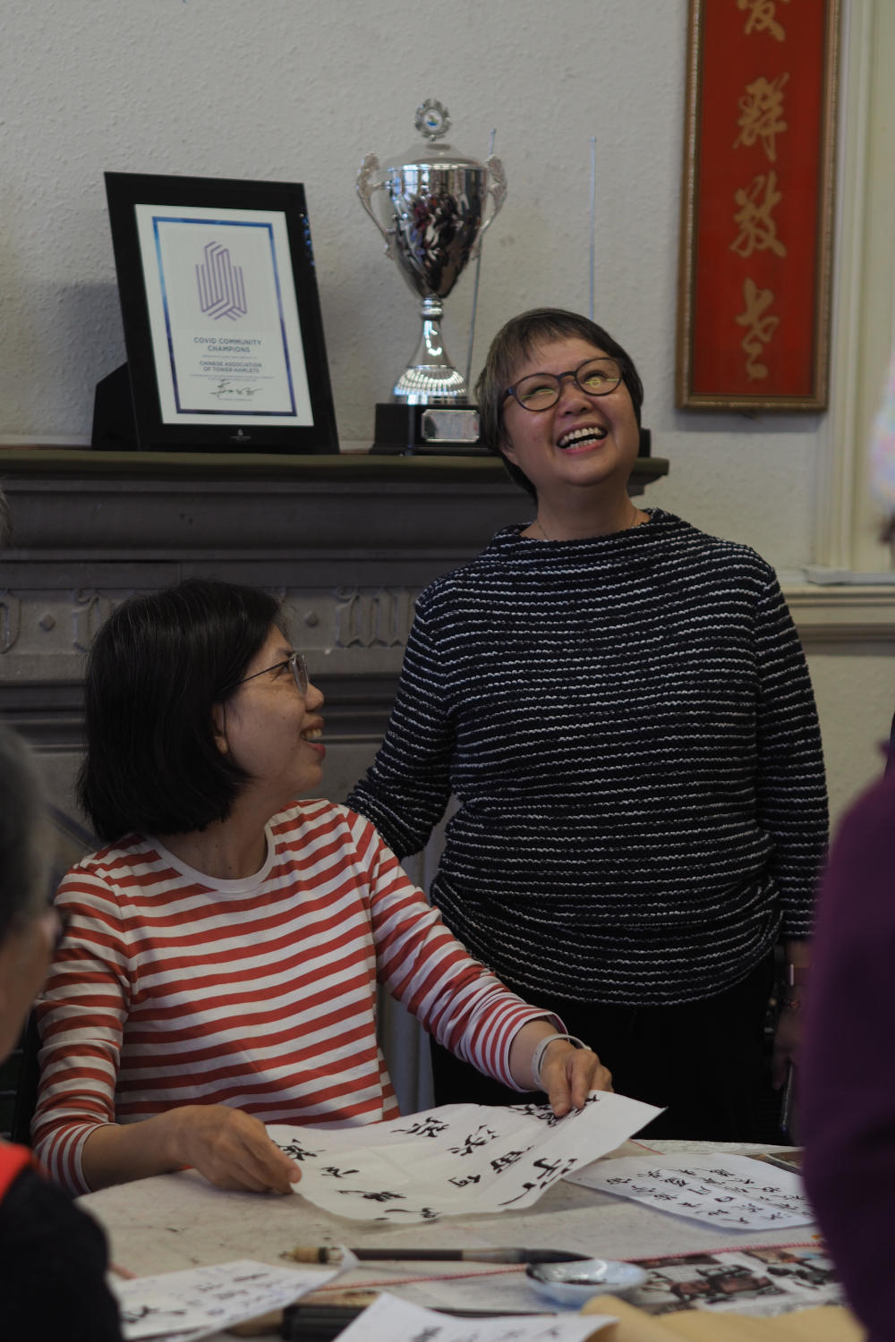 Two ladies laughing at the Chinese Association of Tower Hamlets in Limehouse. 