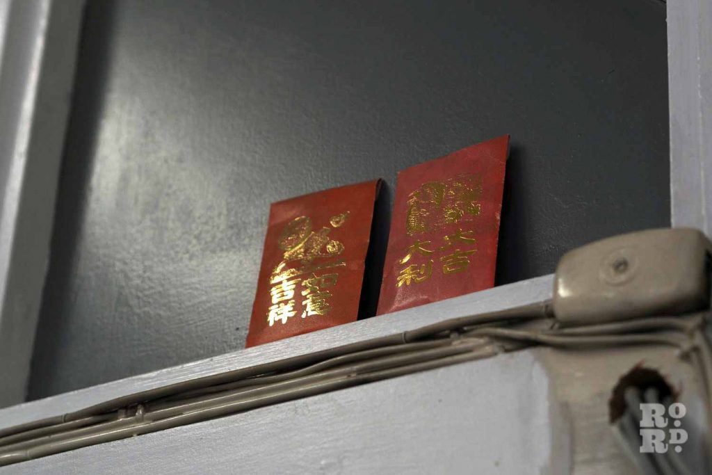 Red packets placed above a doorframe at the Chinese association of Tower Hamlets in Limehouse.
