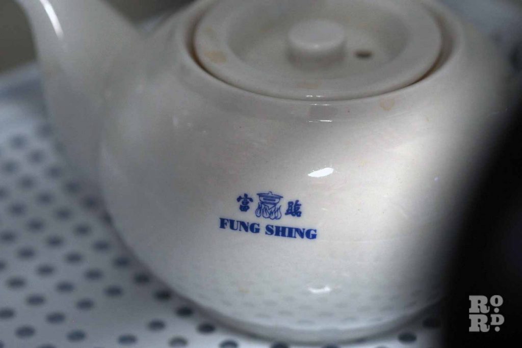 A teapot with Chinese characters on it at the Chinese Association of Tower Hamlets.