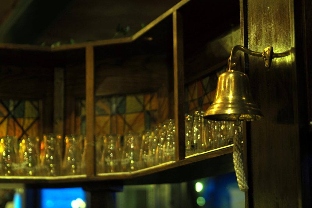 Bell hanging behind the bar in The Queen's Head in Limehouse.