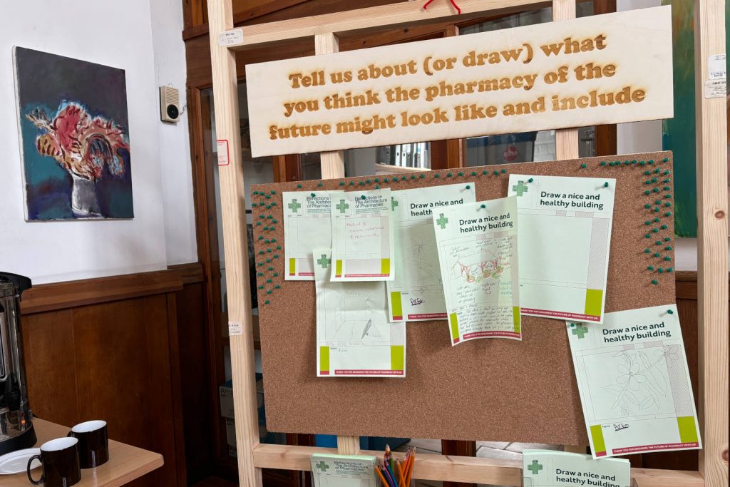 Board with handwritten notes in the Architecture of Pharmacies exhibition at the Bromley-by-Bow Centre in East London.