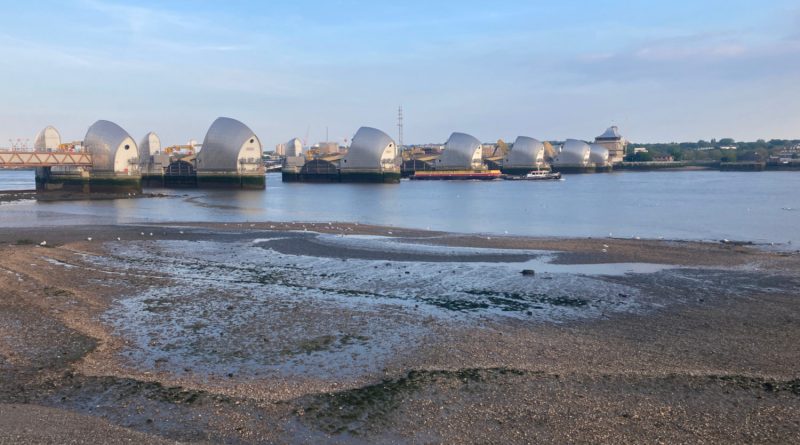Sunset view of metal structures that make up the Thames Barrier, in Silvertown, East London.