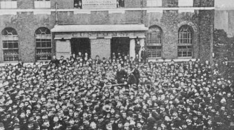 A meeting of striking dockworkers outside West India Quay, East London, during the Great Dock Strike, 1889.