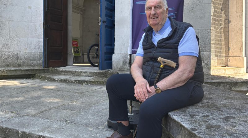 Derrick Cutler sitting on the steps of St Anne's Church in Limehouse, East London.
