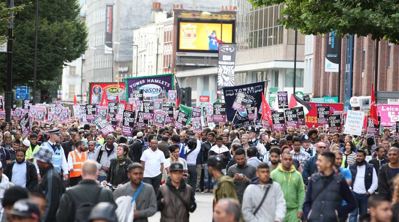 Protesters holding anti-EDL signs in Whitechapel, London